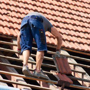 Man working in the roof of a building